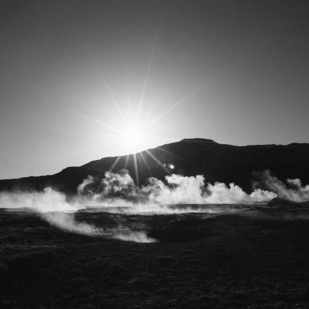 steam rising in front of a mountain